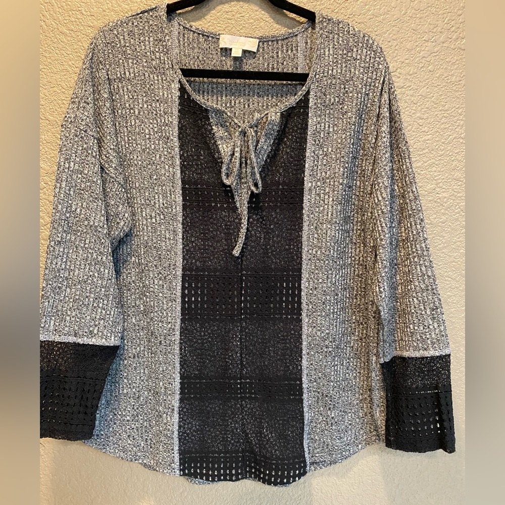 Women’s black and gray, knit like top.  Long sleeve tie at neckline with vneck